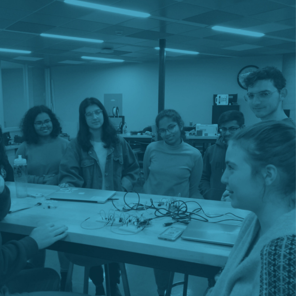 Group of students observing electronic circuits