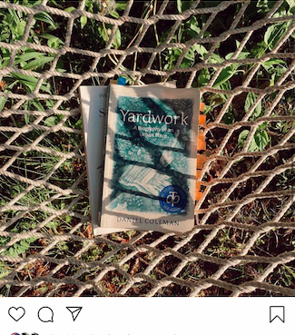 Screenshot of a post from an instagram feed of two books on a hammock. On top is Yardwork by Daniel Coleman.
