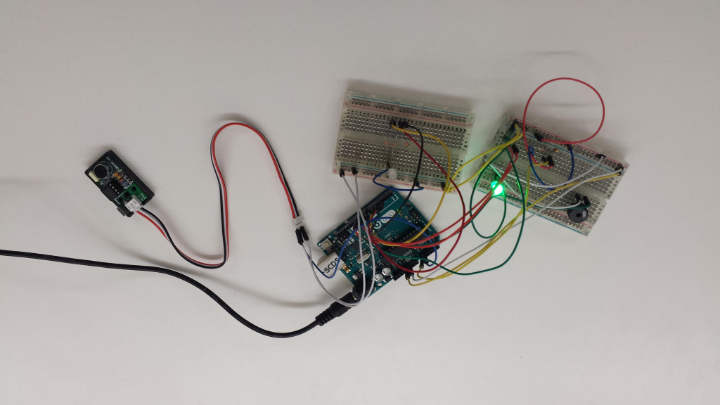 Arduino device with wires and a green bulb