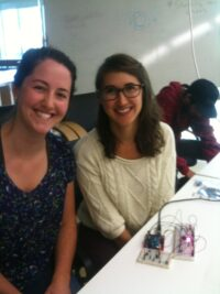 Picture of two students, Stephanie and Julia, at an Arduino board.