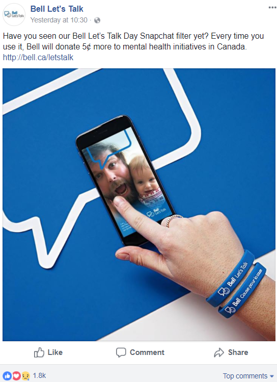 Image: Picture of a white dad and child on a smartphone using the Bell Let's Talk filter. White hand is touching the screen, wearing Bell Let's Talk wristbands.