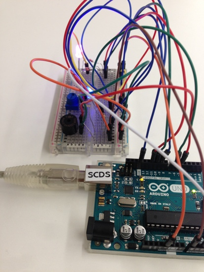 An Arduino device with a purple light