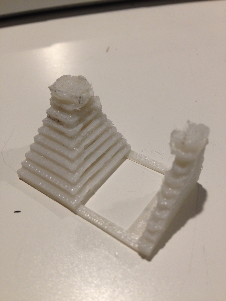 A 3D printed object. It has a pyramid-esque shape on one side and a flat, triangular shape on the other