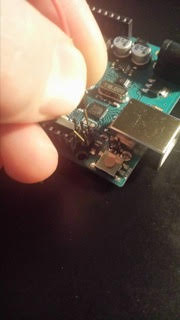 A hand handling a circuit board