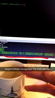 Snapchat image that says "SuperCollider recognizes the midi device!" Photo shows computer code and a coffee mug on a desk